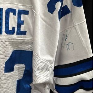 Dallas Cowboys jersey signed by the player Choice #23. Picture of him signing it